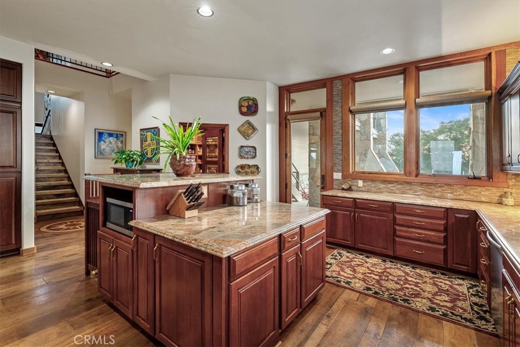 76346 Bryson Hesperia Road Bradley, CA 93426 - Photo 12 of 58 a kitchen with a stove a sink and a wooden cabinets