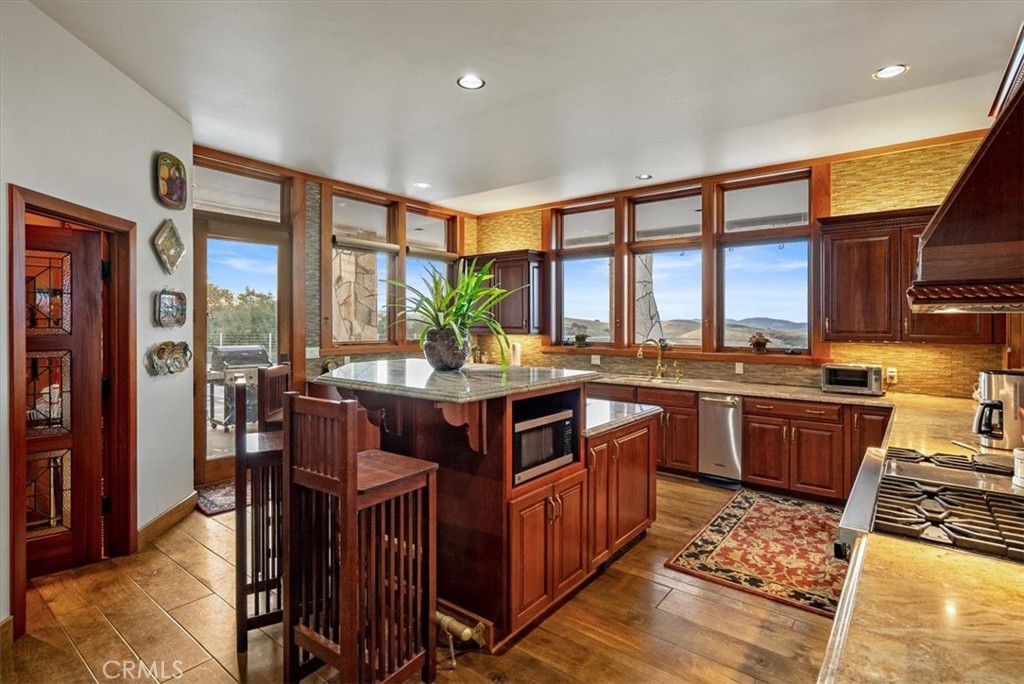 76346 Bryson Hesperia Road Bradley, CA 93426 - Photo 13 of 58 a kitchen with stainless steel appliances granite countertop a stove a sink and a refrigerator