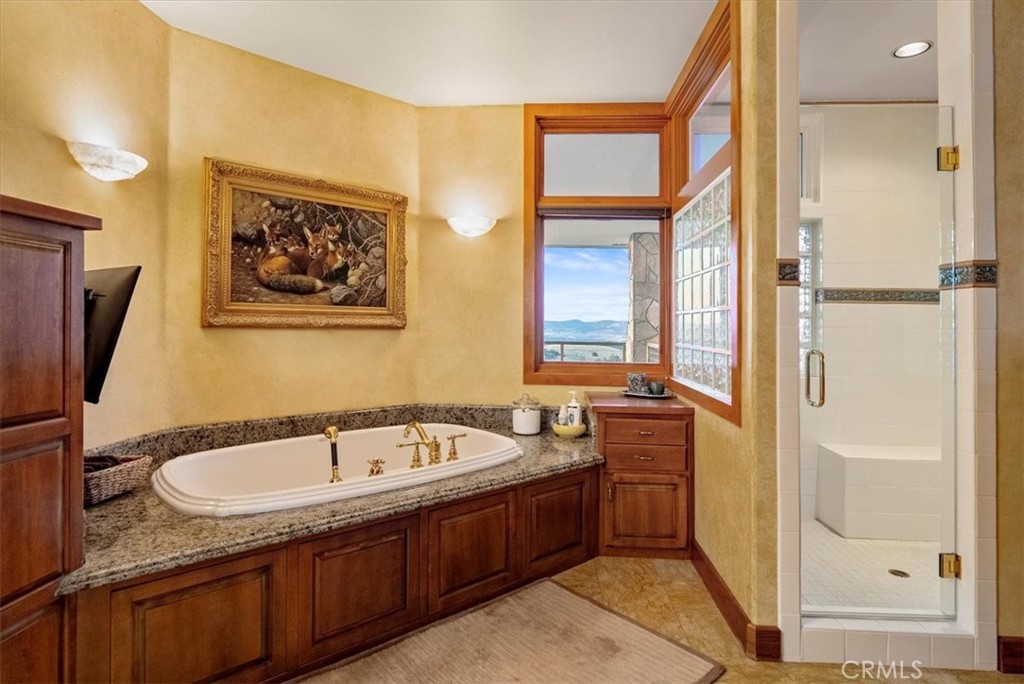 76346 Bryson Hesperia Road Bradley, CA 93426 - Photo 22 of 58 a bathroom with a tub sink and mirror