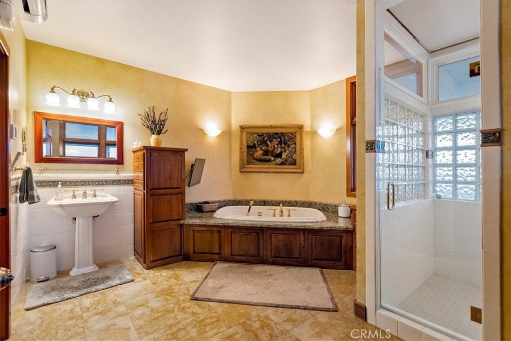 76346 Bryson Hesperia Road Bradley, CA 93426 - Photo 23 of 58 a bathroom with a sink a mirror and a shower