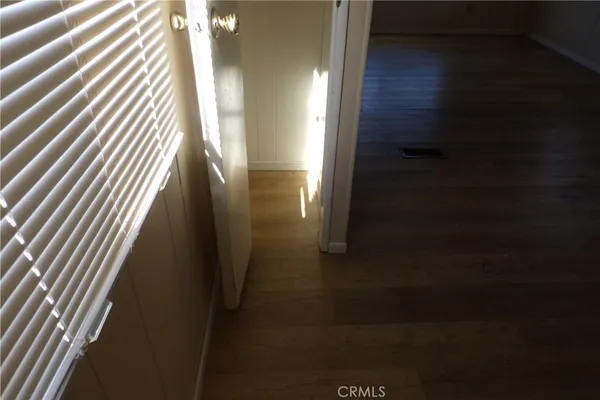 an empty room with wooden floor