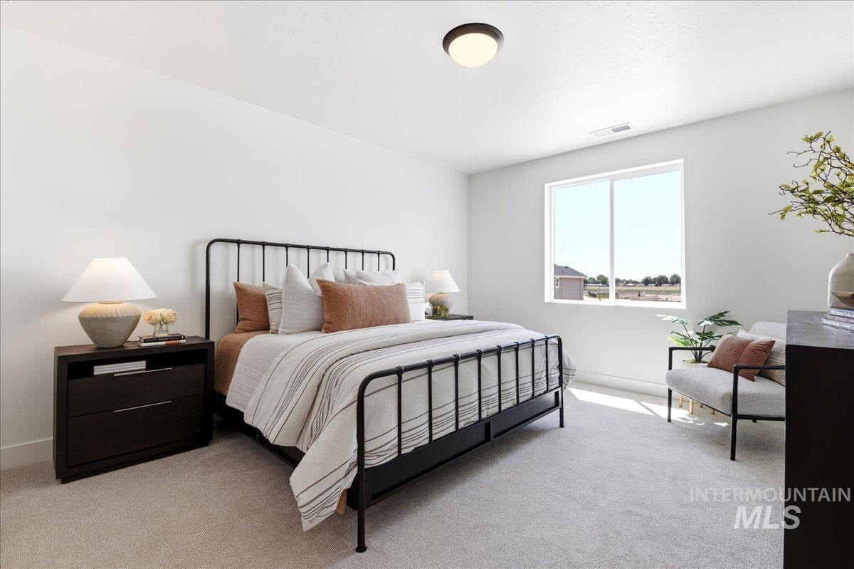 3405 Elliptical Lane Caldwell, ID 83607 - Photo 8 of 17 Carpeted room featuring a large window, a flush-mount ceiling light fixture, and white walls