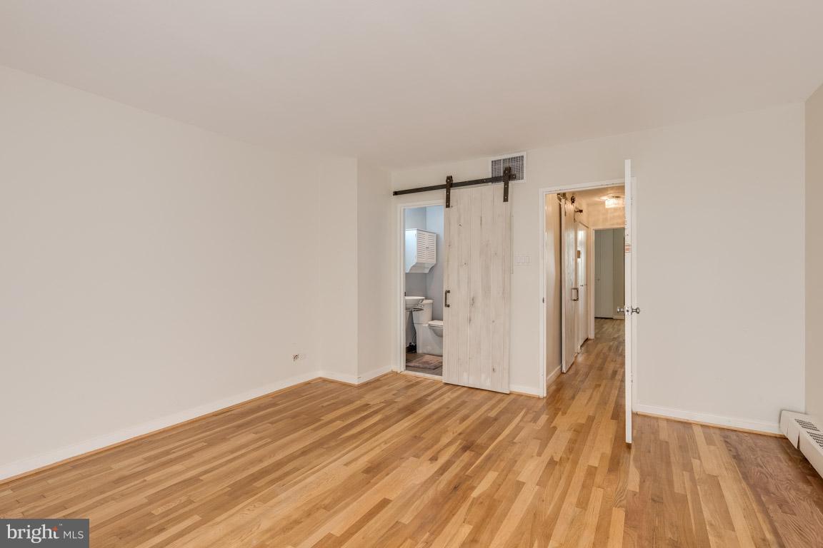 292 M Street Southwest, Unit 292 Washington, DC 20024 - Photo 12 of 29 Sliding barn doors lead to your en suite