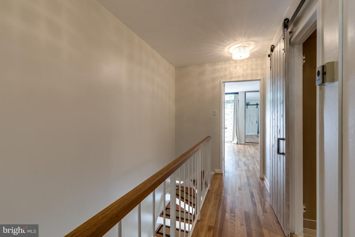 292 M Street Southwest, Unit 292 Washington, DC 20024 - Photo 17 of 29 Upstairs hallway w/ barn doors to second bath