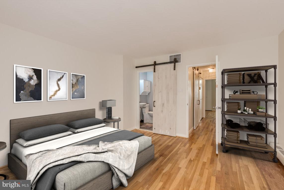 292 M Street Southwest, Unit 292 Washington, DC 20024 - Photo 10 of 29 Owner's bedroom w/ sliding barn door to en-suite