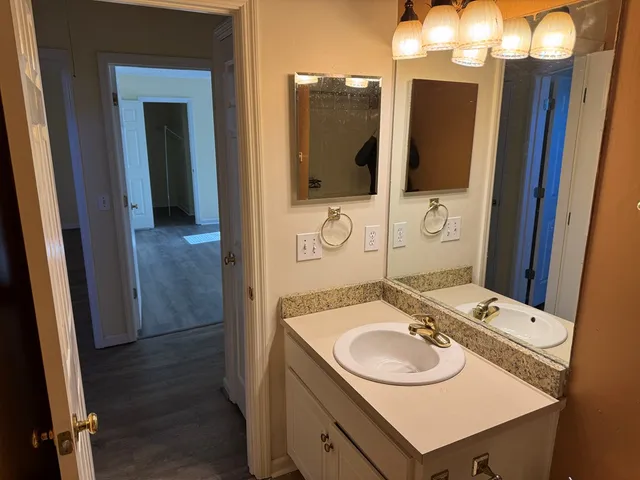 a bathroom with a sink vanity and mirror