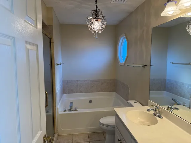 a bathroom with a sink a toilet and bathtub