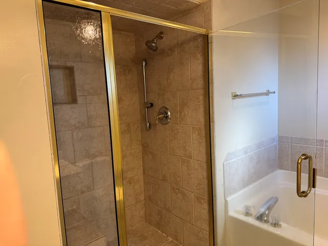 a bathroom with a shower and a sink