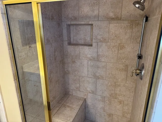 a bathroom with a shower and a sink