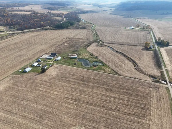 an aerial view of a house with a yard and sitting space