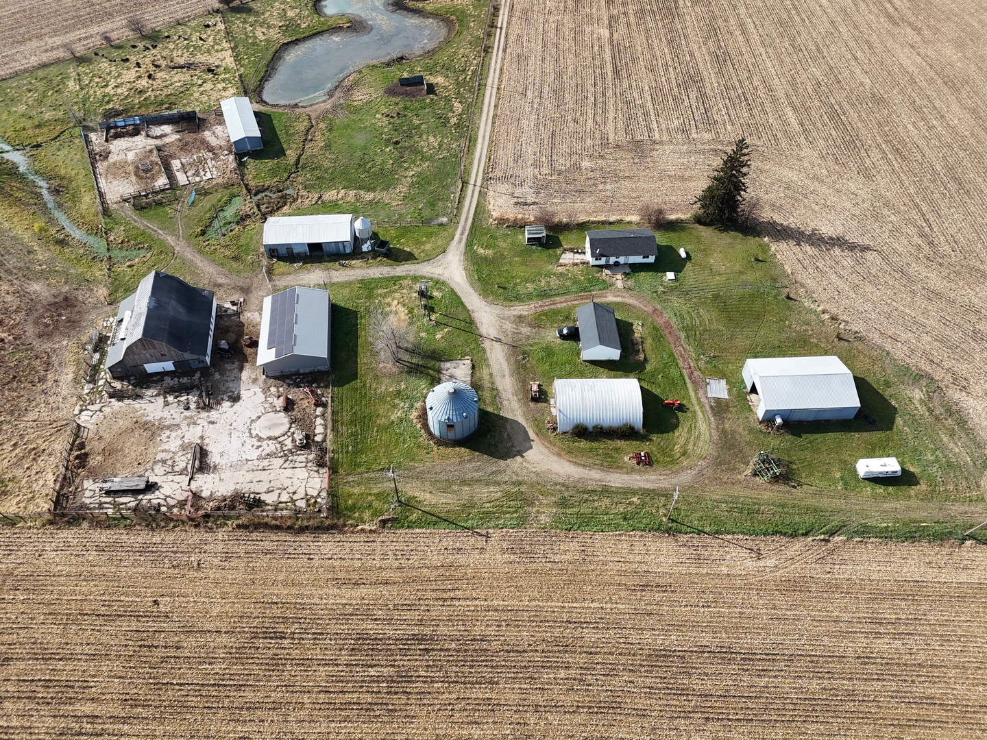6977 South Elmoville Road Stockton, IL 61085 - Photo 4 of 14 an aerial view of a house with a yard and sitting space