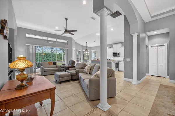a kitchen with stainless steel appliances granite countertop a stove top oven a sink dishwasher and white cabinets with wooden floor