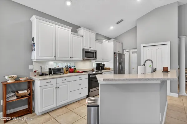 a kitchen with stainless steel appliances granite countertop a sink dishwasher stove and refrigerator