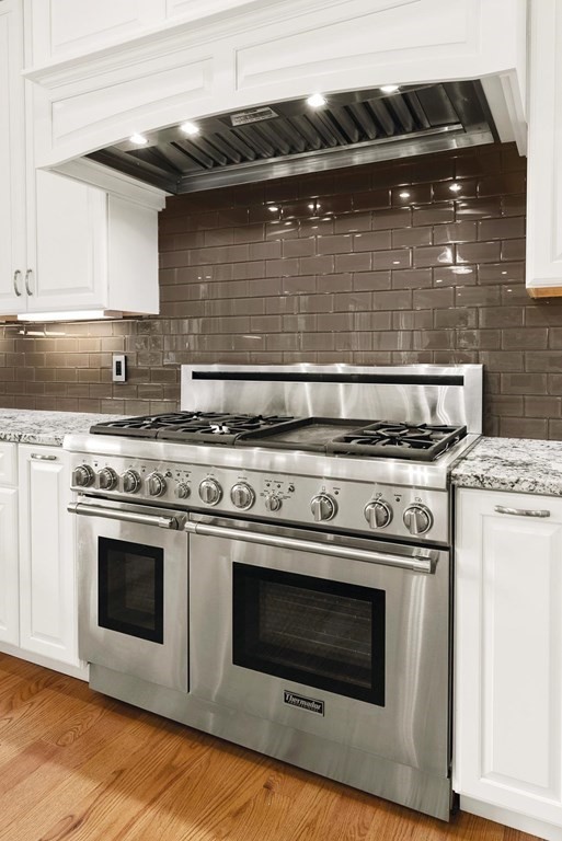 53 Van Roosen Road Newton, MA 02459 - Photo 13 of 34 a stove top oven sitting inside of a kitchen