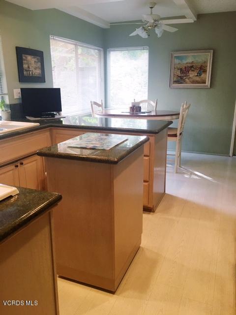 1088 Warwick Avenue Thousand Oaks, CA 91360 - Photo 3 of 11 a kitchen with kitchen island a sink stove and view of living room