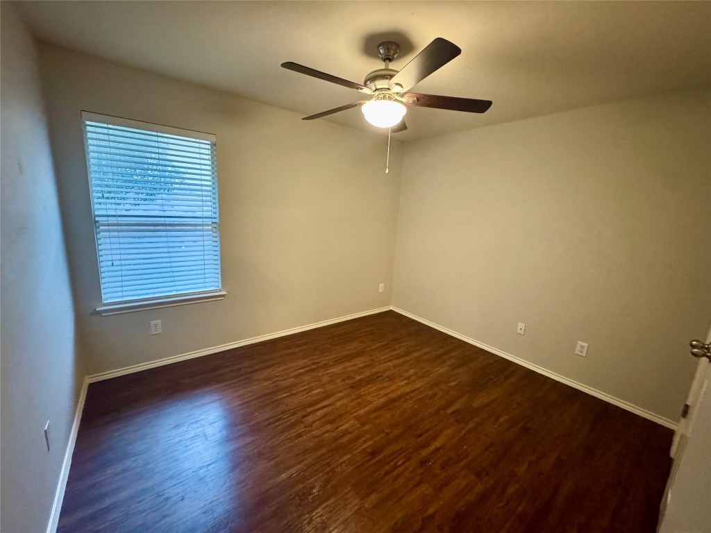 205 Bluebonnet Trail Leander, TX 78641 - Photo 11 of 22 an empty room with wooden floor fan and windows