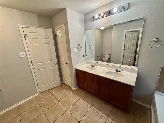 a bathroom with a double vanity sink a mirror and a shower