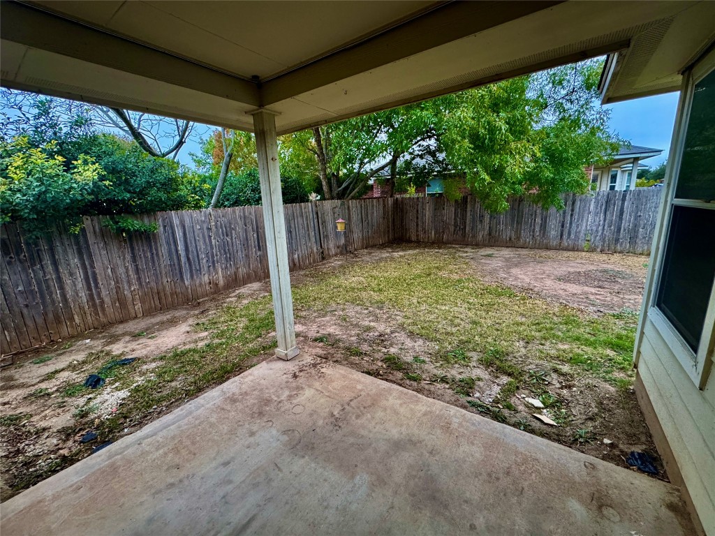 205 Bluebonnet Trail Leander, TX 78641 - Photo 18 of 22 a backyard with large trees and wooden fence