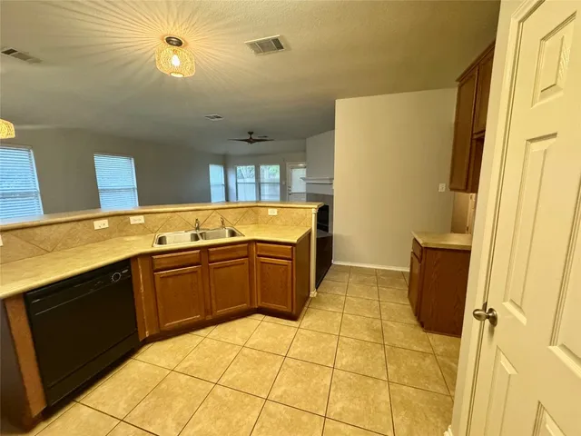 a kitchen with a sink and a refrigerator