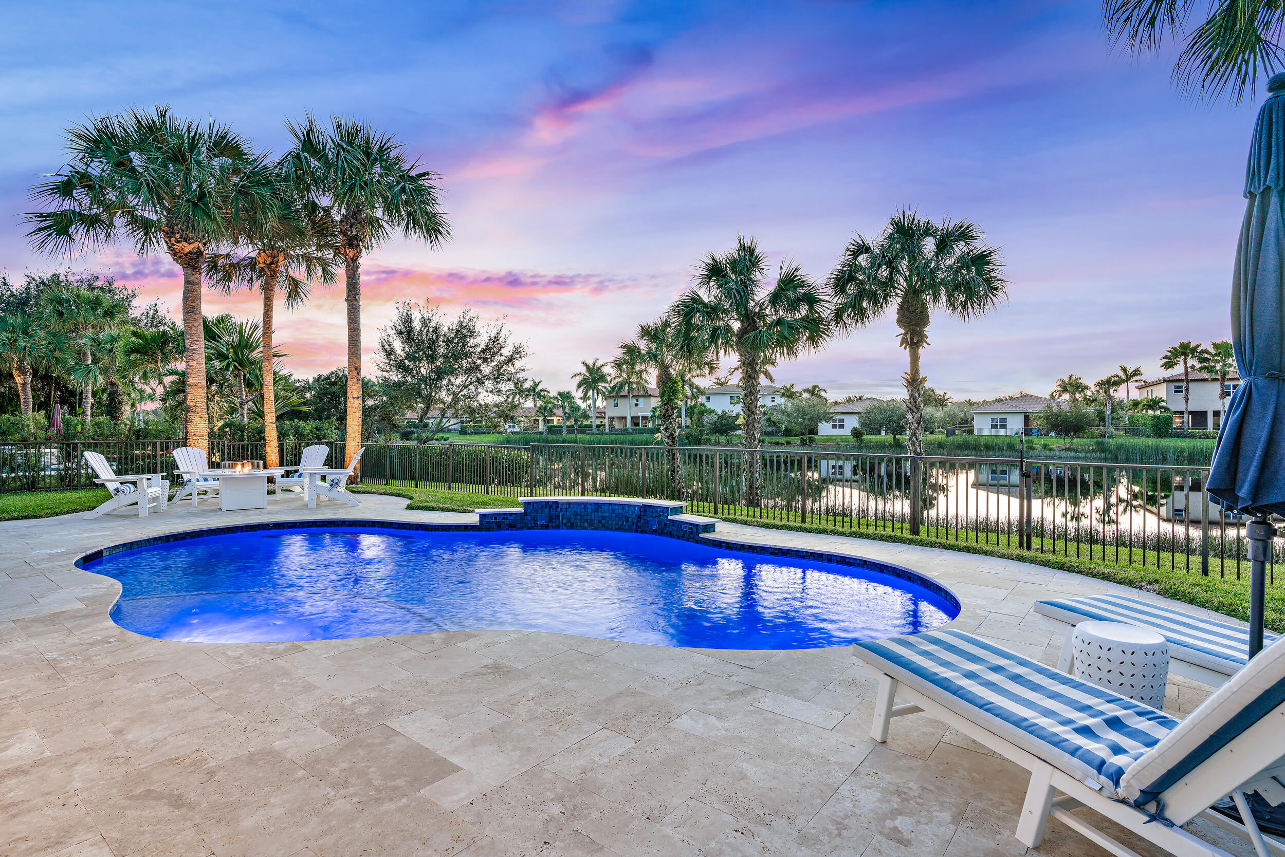a view of swimming pool with outdoor seating and yard in back