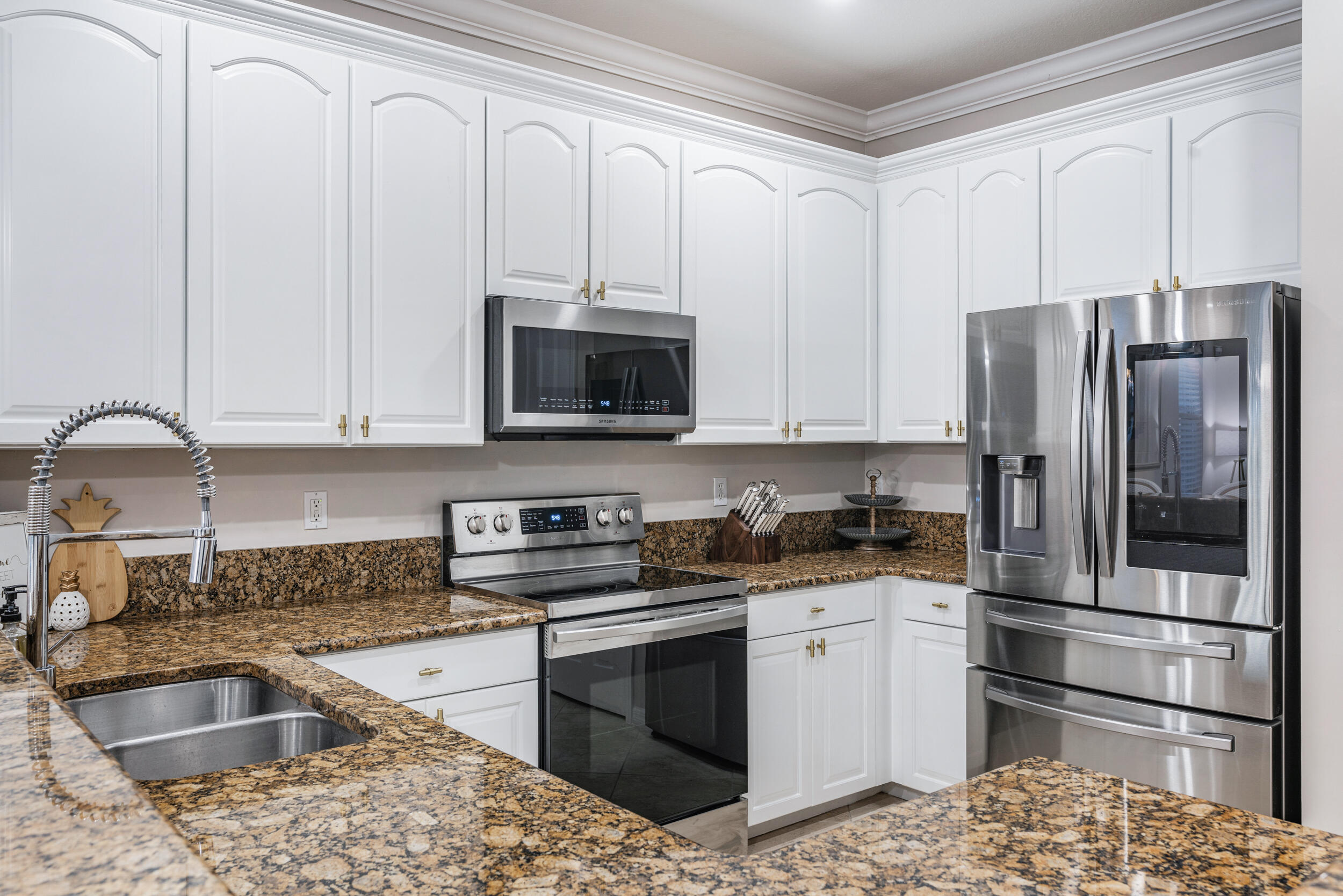 237 Porgee Rock Place Jupiter, FL 33458 - Photo 16 of 47 a kitchen with stainless steel appliances granite countertop a refrigerator sink and stove