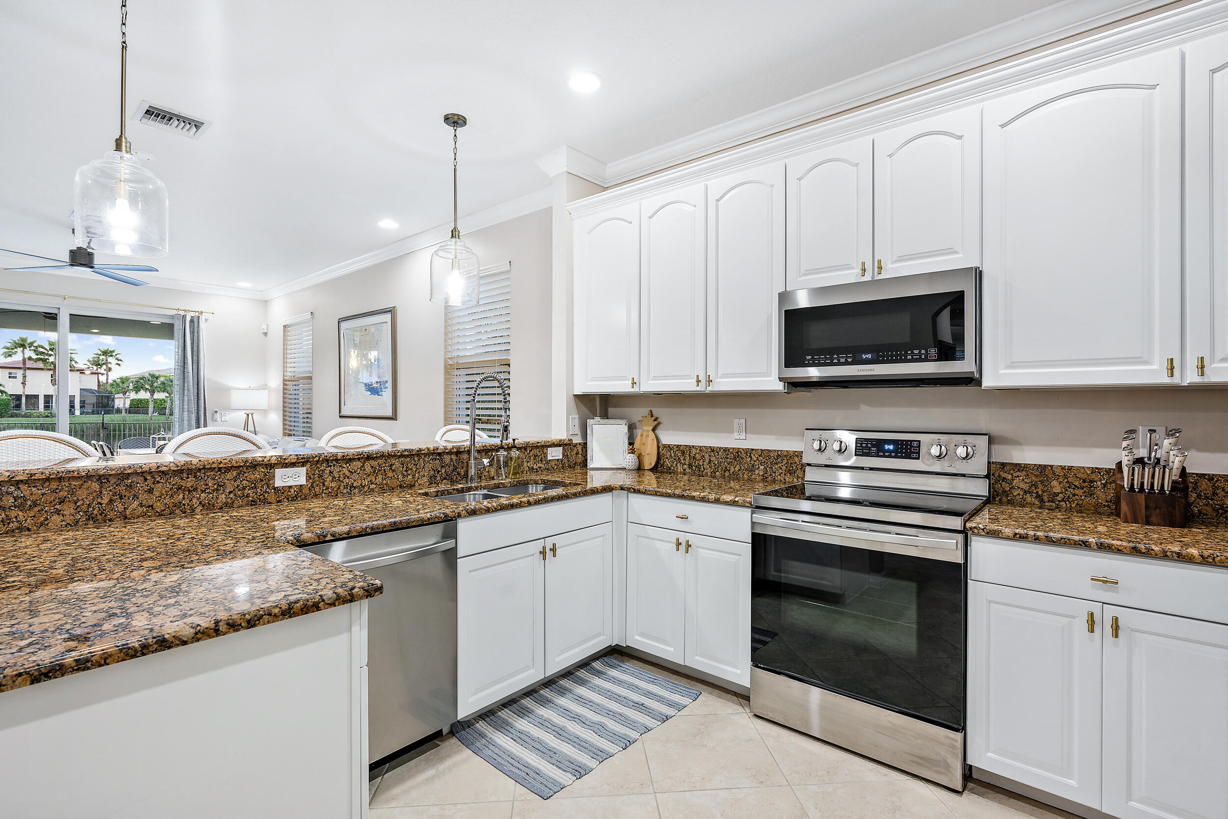 237 Porgee Rock Place Jupiter, FL 33458 - Photo 17 of 47 a kitchen with stainless steel appliances granite countertop a sink and a stove
