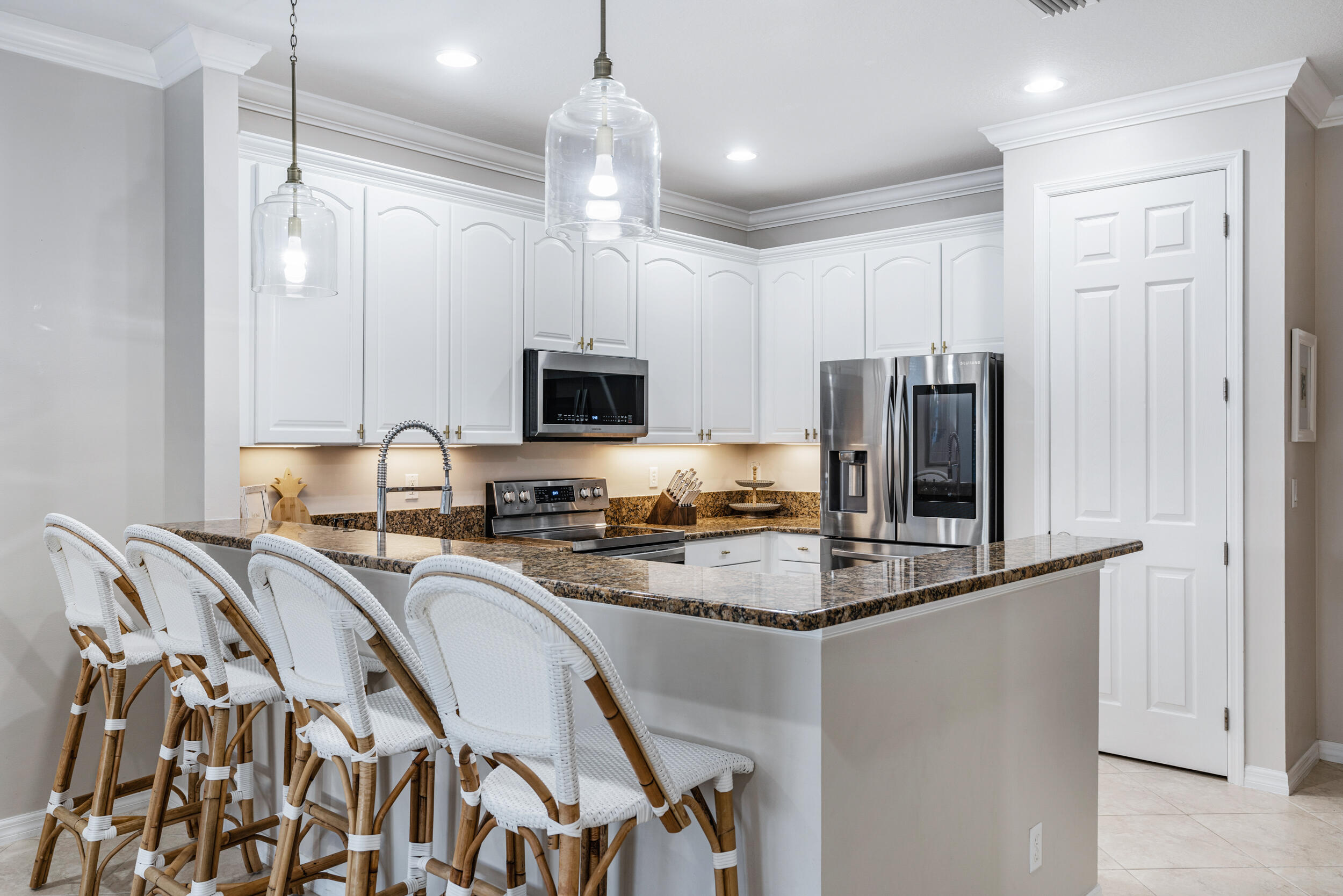 237 Porgee Rock Place Jupiter, FL 33458 - Photo 18 of 47 a kitchen with refrigerator a stove a sink and chairs