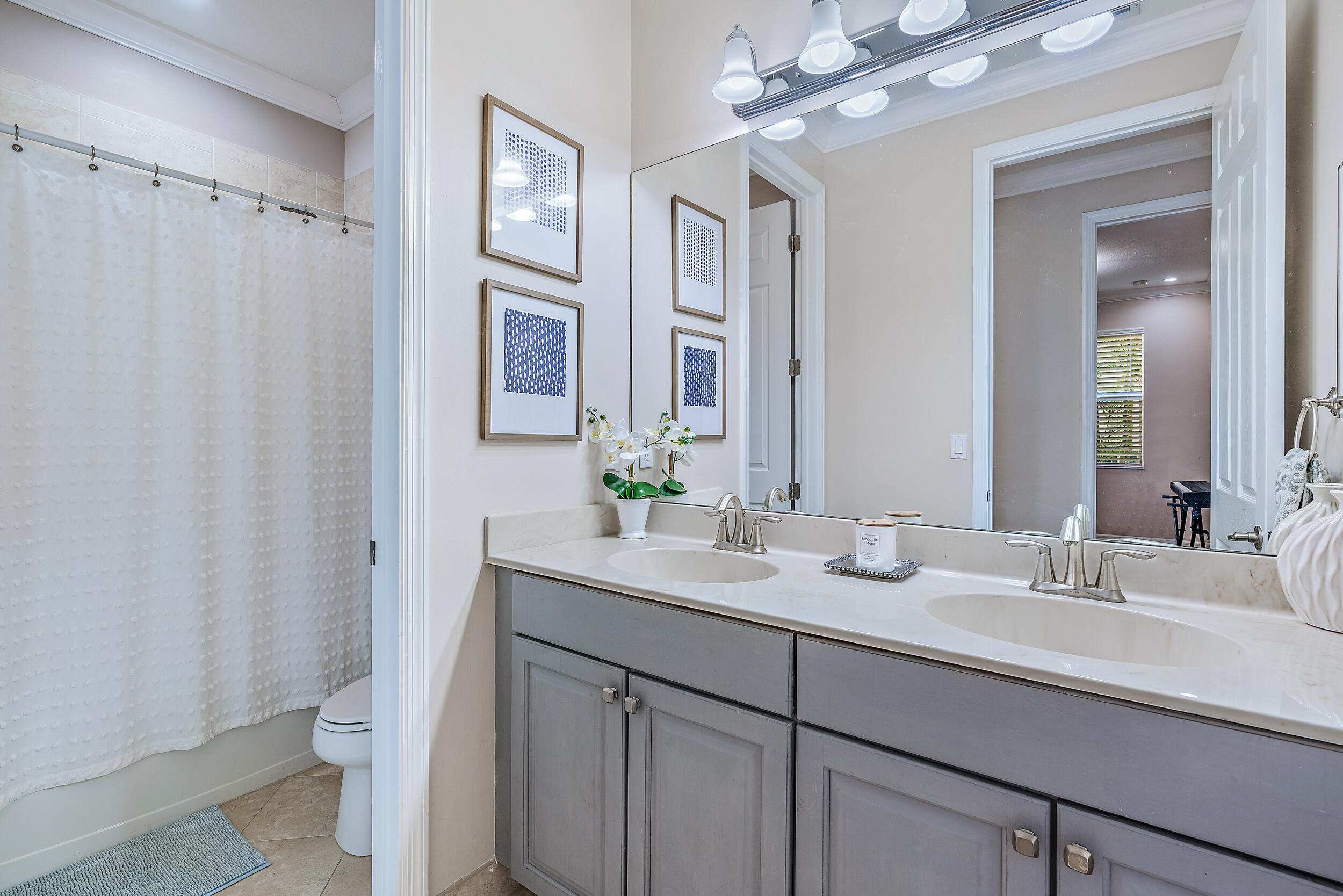 237 Porgee Rock Place Jupiter, FL 33458 - Photo 32 of 47 a bathroom with a double vanity sink mirror and toilet