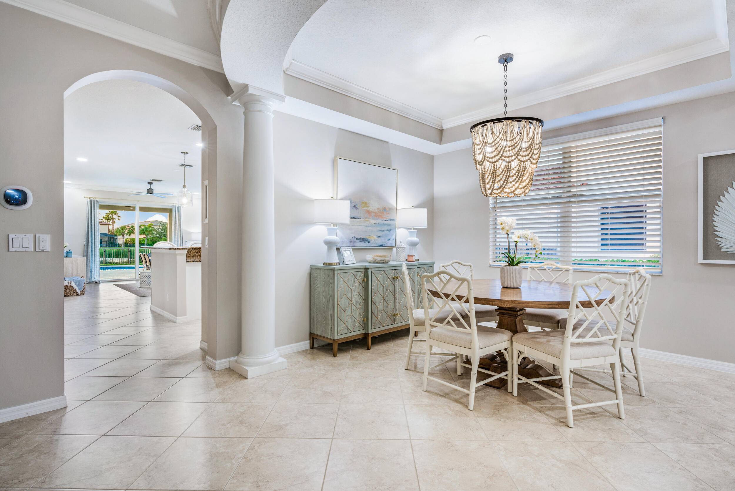 237 Porgee Rock Place Jupiter, FL 33458 - Photo 10 of 47 a dining room with furniture a chandelier and kitchen view