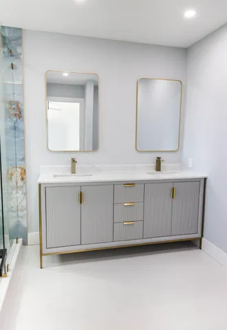 a bathroom with a sink vanity and mirror