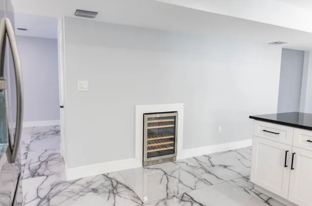 a kitchen with granite countertop a sink a counter top space appliances and cabinets