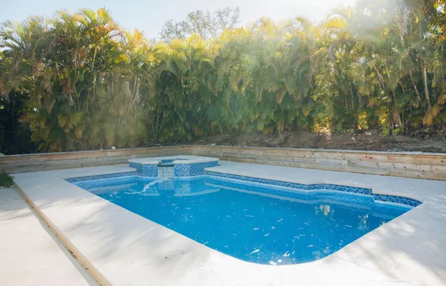 a view of a swimming pool with a yard