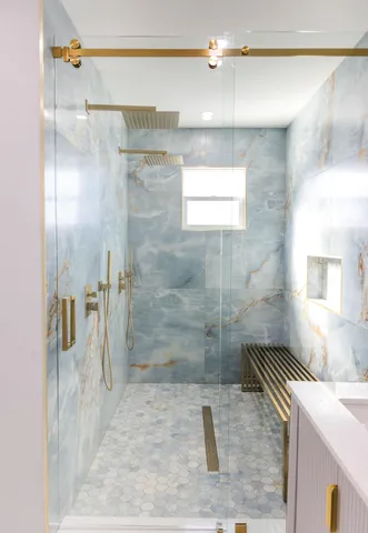 a bathroom with a granite countertop shower a sink and a mirror