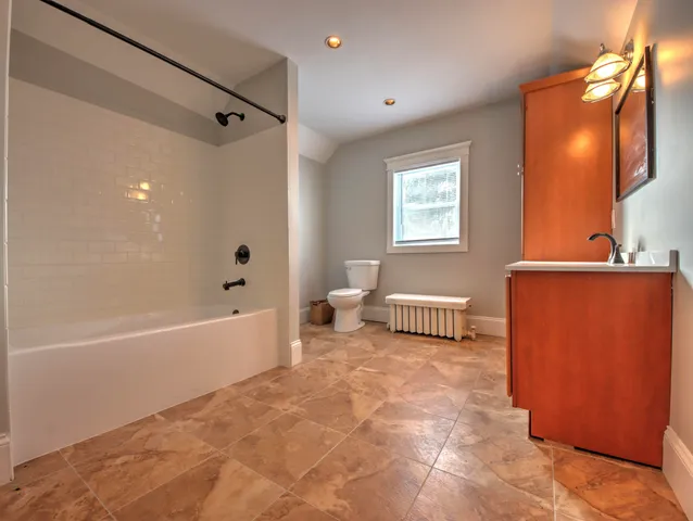 a bathroom with a bathtub sink and toilet
