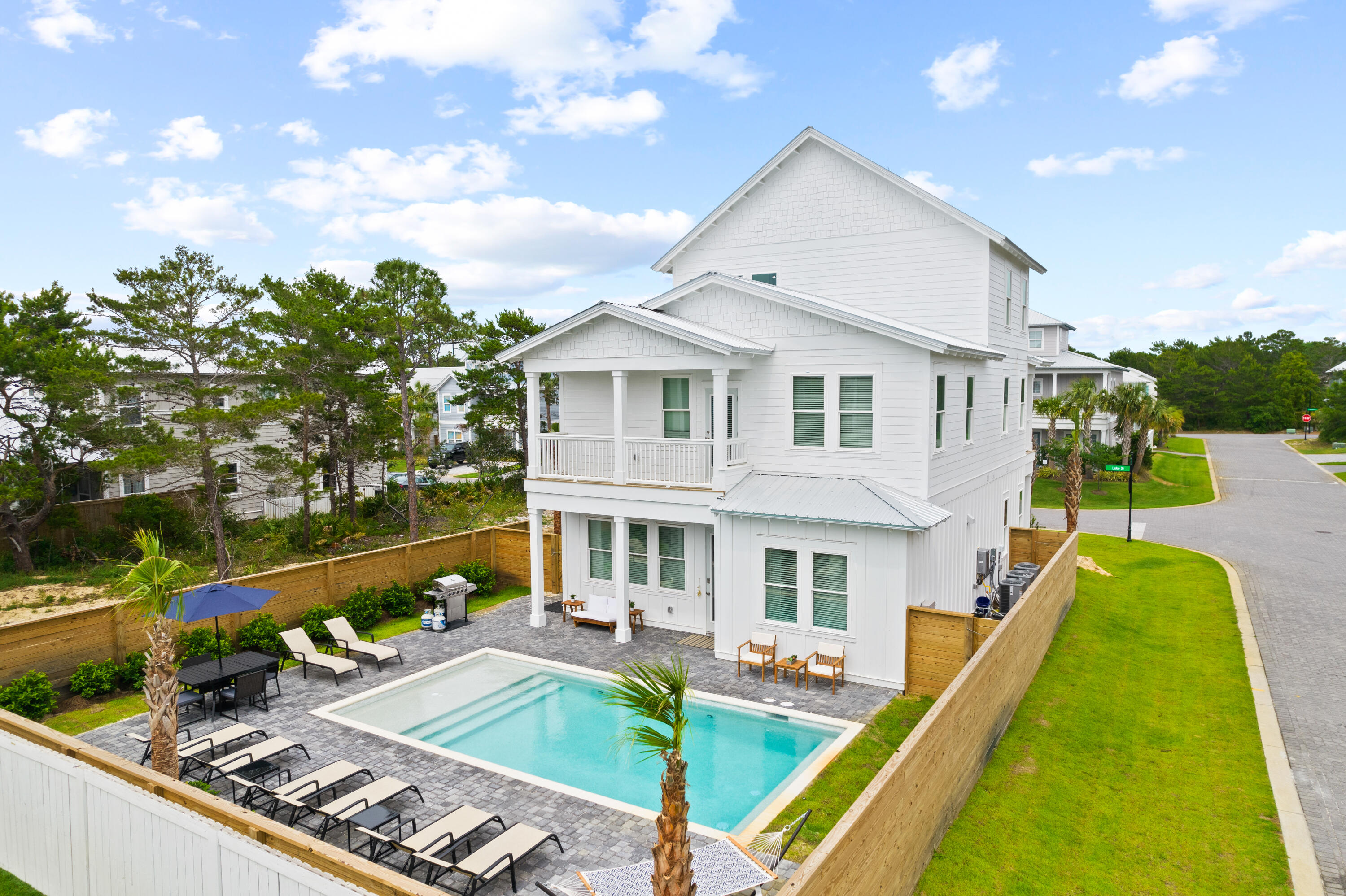 a view of a house with swimming pool and sitting area