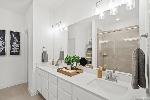 a bathroom with a double vanity sink and a mirror