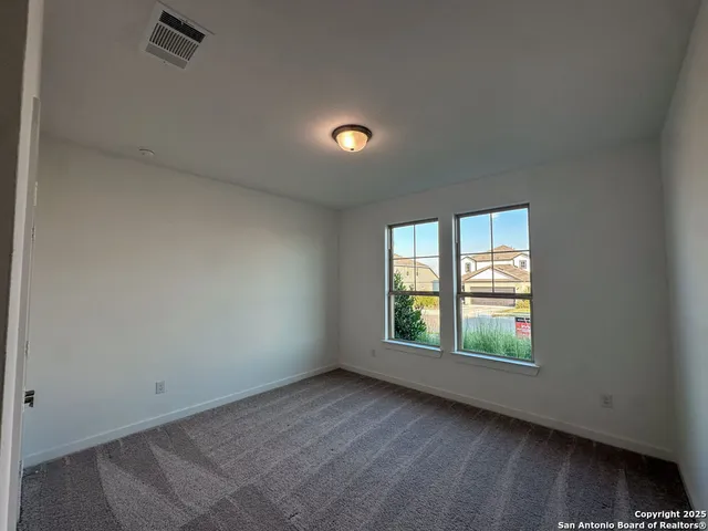 an empty room with windows and closet