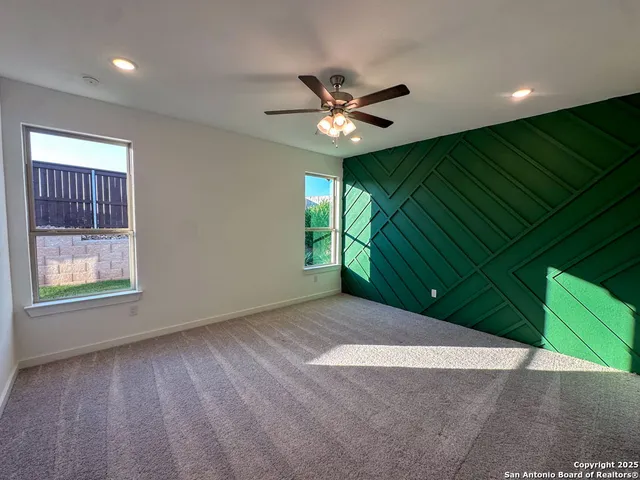 a view of a livingroom with a ceiling fan and a window