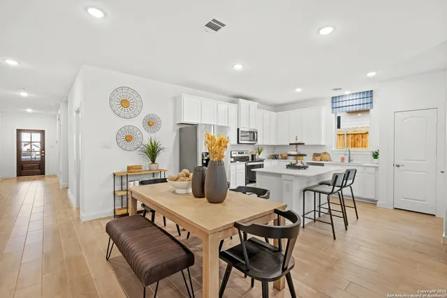 a view of a dining room with furniture and wooden floor