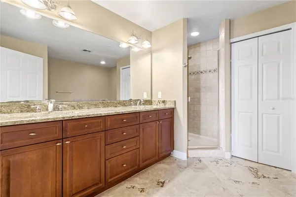 a bathroom with a granite countertop sink mirror and double
