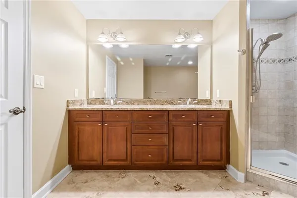 a bathroom with a granite countertop sink and a mirror