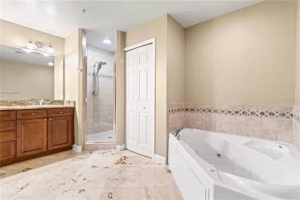 a bathroom with a bathtub sink and shower