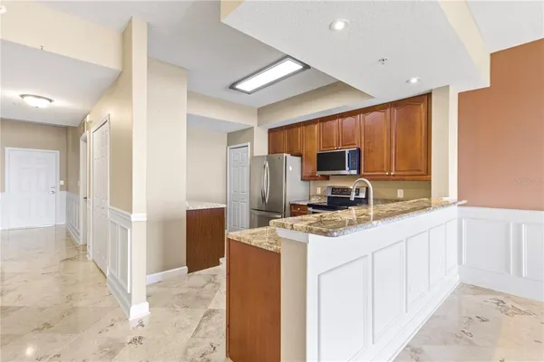 a kitchen with a refrigerator stove and microwave
