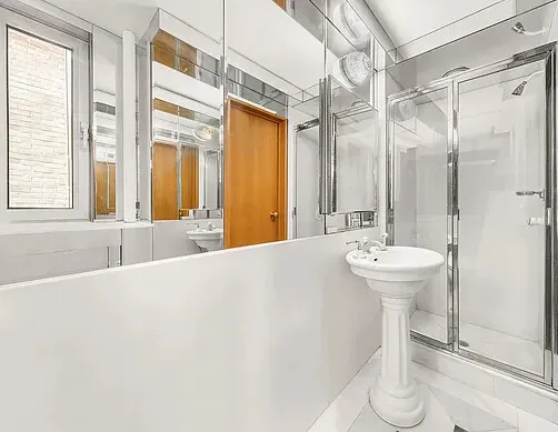 a bathroom with a sink a mirror and a bathtub
