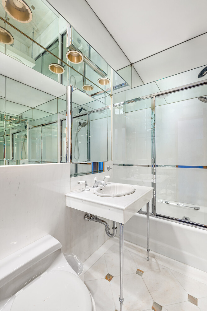 120 Central Park South, Unit 6AB Manhattan, NY 10019 - Photo 9 of 10 a bathroom with a sink and a mirror