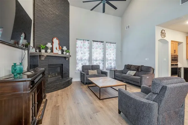 a living room with furniture fireplace and flat screen tv