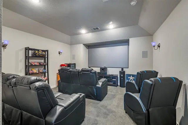 a media room with lots of chairs and a projector screen