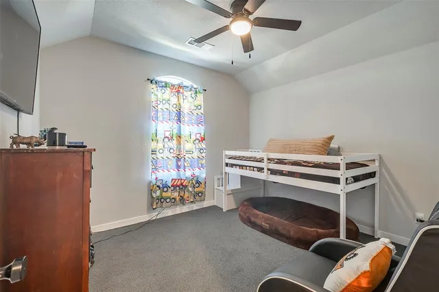 a bedroom with furniture and a window