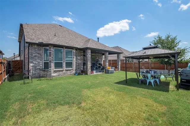 a view of a house with a backyard porch and sitting area