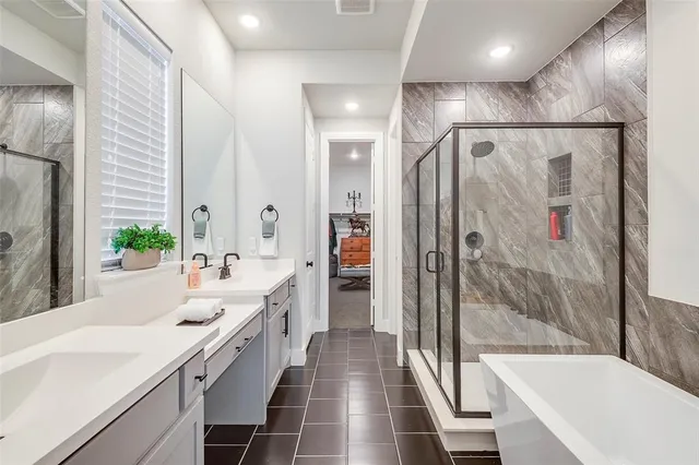 a large white bathroom with a bathtub and a sink